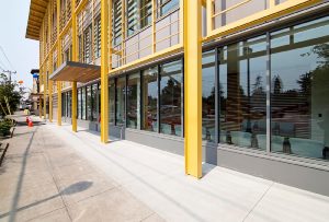 Exterior photo of the Asian Health & Services Center unique yellow exterior wall system