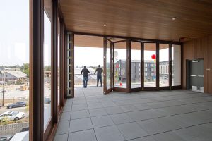 A third-floor terrace features a movable storefront system for all-season use.