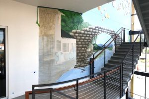 Photo-realistic wall mural in the stairwell at Portland's new Asian Health & Services Center