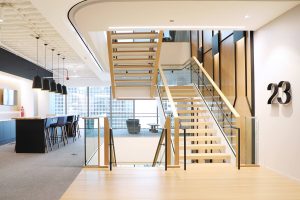 Open staircase with glass railings in light, bright corporate headquarters