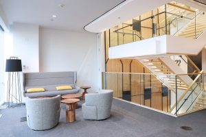 Open staircase with glass railings in light, bright corporate headquarters