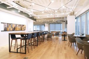Light, bright company headquarters with high top bar seating for employees